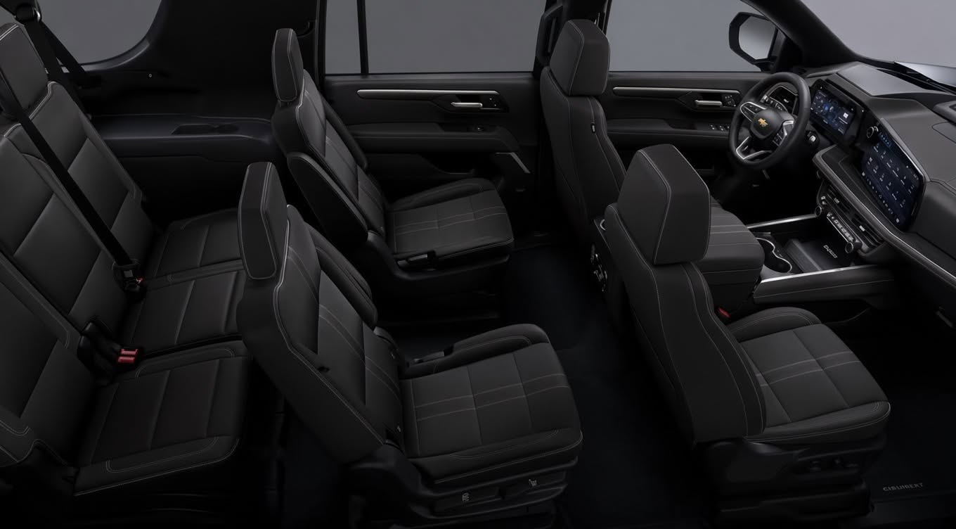 Black leather captain chairs and digital dashboard inside the Alpine Express Chevrolet Suburban
